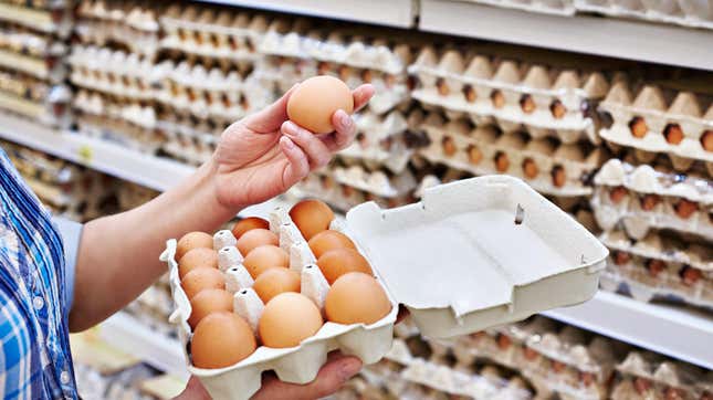 hands holding eggs at store