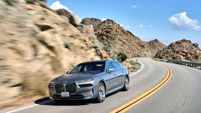 A photo of an electric BMW i7 sedan driving on a road. 