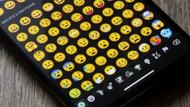 Smartphone with emojis on screen