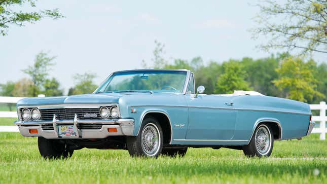 A photo of a pale blue convertible vintage Chevrolet. 