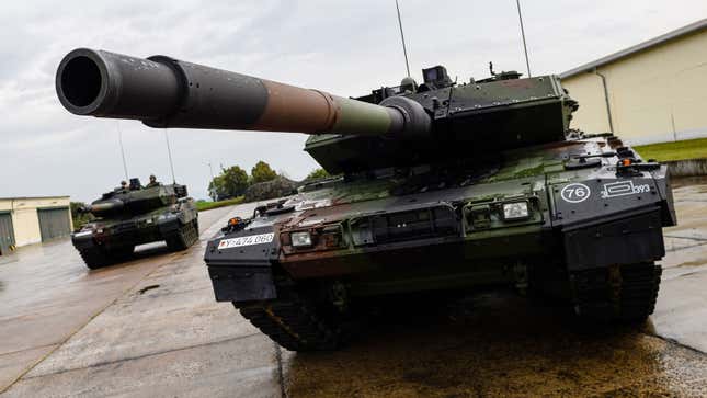 Two tanks parked in a military base