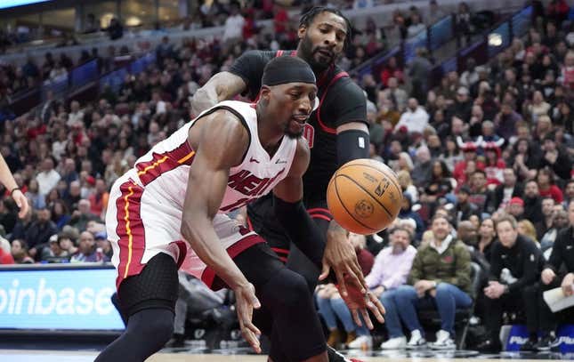 Nov 18, 2023; Chicago, Illinois, USA; Chicago Bulls center Andre Drummond (3) defends Miami Heat center Bam Adebayo (13) during the first half at United Center.