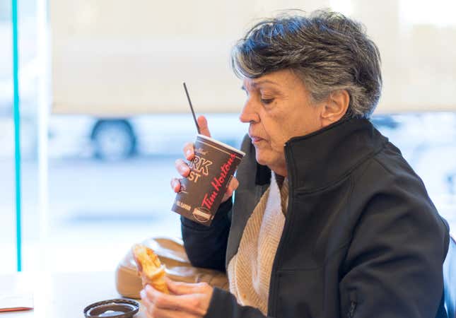 Lady drinking Tim Horton’s coffee in a shop close to chinatown.