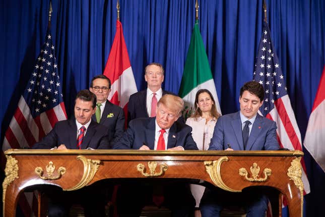 Outgoing Mexican President Enrique Peña Nieto, U.S. President Donald Trump, and Canadian Prime Minister Justin Trudeau sign the agreement during the G20 summit in Buenos Aires, Argentina, on November 30, 2018.