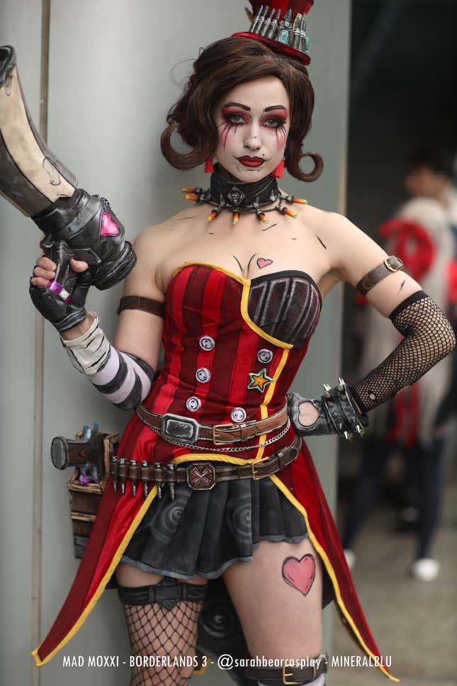 Mad Moxxi stands with one hand on her hip.