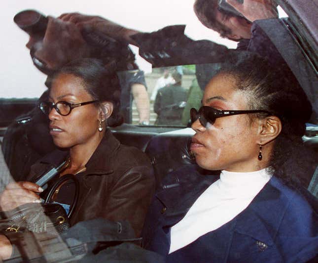 Qubilah Shabazz (right) and her sister Ilyasah (left) wait in a car 03 June outside family court in Yonkers after attending a court hearing for Qubilah’s son Malcom