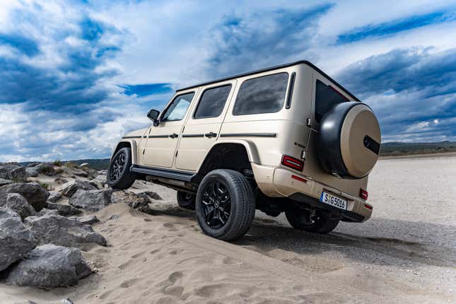 Rear 3/4 view of a matte gold 2025 Mercedes-Benz G550