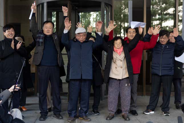 Family members of victims react outside the Supreme Court of Korea in Seoul, South Korea, Thursday, Dec. 28, 2023. South Korea’s top court on Thursday ordered a third Japanese company to compensate some of its former wartime Korean employees for forced labor, the second such ruling in a week. (Yun Dong-jin/Yonhap via AP)