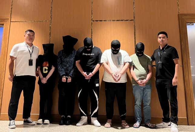 FILE - In this photo released by Xinhua News Agency, Myanmar police hand over five telecom and internet fraud suspects to Chinese police at Yangon International Airport in Yangon, Myanmar, Aug. 26, 2023. Confession videos and national TV broadcasts of the arrests for high-profile suspects are all showcasing a new intensity in China&#39;s crackdown against cyberscams. (Chinese embassy in Myanmar/Xinhua via AP)