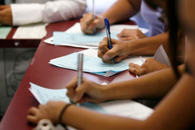 Applicants fill out forms during a job fair at the Southeast LA-Crenshaw WorkSource Center in Los Angeles November 20, 2009. In a depressed neighborhood in the City of Angels, hundreds of good jobs appeared to fall from the sky last week. Young and middle-aged Los Angeles residents, mostly blacks and Hispanics, lined up down the block at an employment office for more than 600 jobs, paying $14 an hour and higher with free healthcare, at new JW Marriott and Ritz Carlton hotels downtown. Picture taken November 20, 2009. 