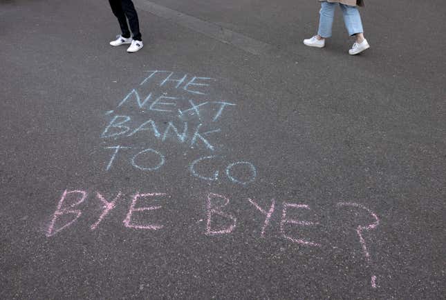 A slogan is written on the sidewalk in front of the global headquarters of Swiss bank Credit Suisse.