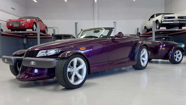 the purple prowler parked in a garage with its trailer attached