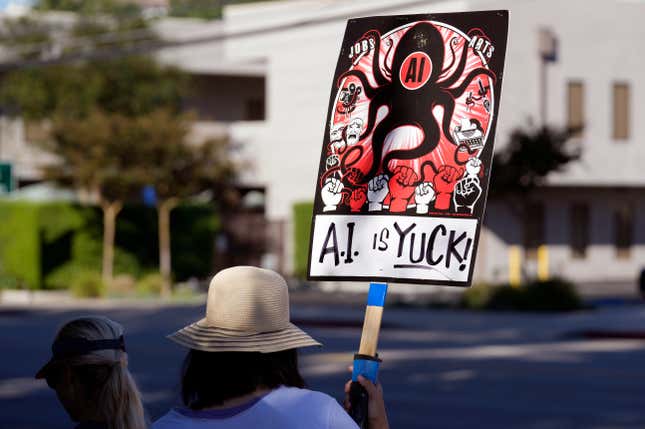 A striking SAG-AFTRA member holds up a sign in a picket line outside Walt Disney Studios, Friday, Oct. 20, 2023, in Burbank, Calif. Saturday marks the 100th day of the SAG-AFTRA strike, which is now the longest of the union&#39;s history. (AP Photo/Chris Pizzello)