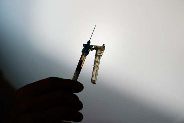 FILE - A syringe is prepared at a clinic in Norristown, Pa., Dec. 7, 2021. The Environmental Protection Agency finalized a rule Thursday, March 14, 2024, imposing stricter limits on a chemical used to sterilize medical equipment after finding a higher-than-expected cancer risk at facilities that use ethylene oxide to clean billions of devices including catheters and syringes. (AP Photo/Matt Rourke, File)