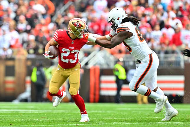 CLEVELAND, OHIO - OCTOBER 15: Christian McCaffrey #23 of the San Francisco 49ers stiff arms Za&#39;Darius Smith #99 of the Cleveland Browns during the first half at Cleveland Browns Stadium on October 15, 2023 in Cleveland, Ohio. (Photo by Jason Miller/Getty Images)