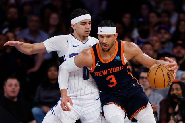 Josh Hart of the New York Knicks dribbles against Anthony Black of the Orlando Magic during the first half at Madison Square Garden on March 08, 2024 in New York City.