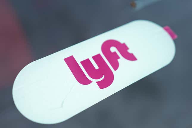 close-up of lyft logo on a white pill-shaped background on a car window