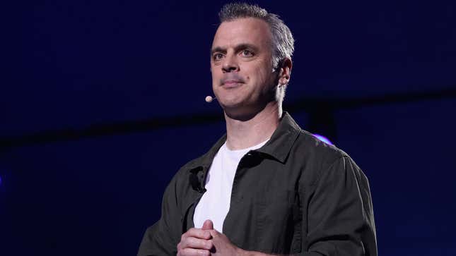 Pete Hines stands in front of a navy blue background.