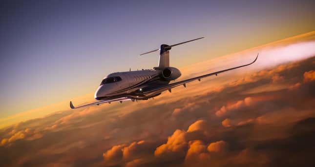 Private jet flying over clouds