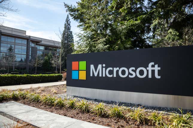 The Microsoft Logo on a sign in front of an office complex.
