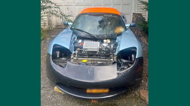 Image for article titled This Incredibly Trashed Tesla Roadster Could Be Yours