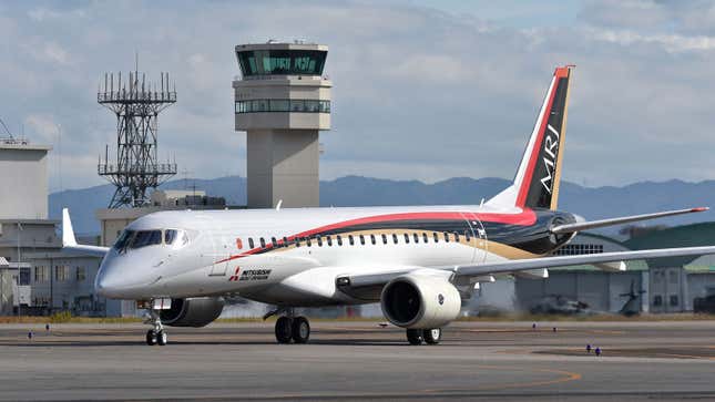 A photo of a Mitsubishi aircraft at an airport. 