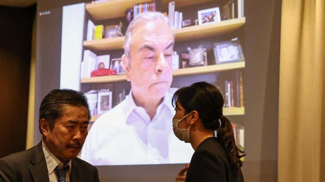 Former Nissan CEO Carlos Ghosn speaks via a video link as his lawyer Nobuo Gohara (L) looks on during a press conference at the Foreign Correspondents' Club of Japan (FCCJ) on July 18, 2023 in Tokyo, Japan.