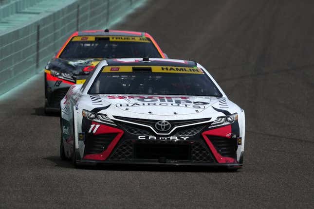 Oct 22, 2023; Homestead, Florida, USA; NASCAR Cup Series driver Denny Hamlin (11) leads NASCAR Cup Series driver Martin Truex Jr (19) during the 4EVER 400 presented by Mobil 1 at Homestead-Miami Speedway.