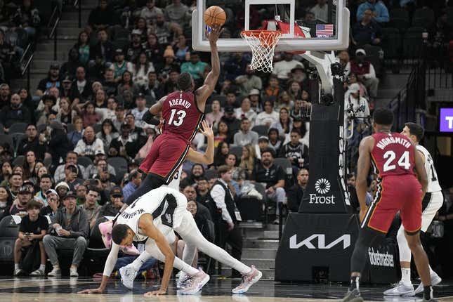 Nov 12, 2023; San Antonio, Texas, USA; Miami Heat center Bam Adebayo (13) drives to the basket past San Antonio Spurs forward Victor Wembanyama (1) during the first half at Frost Bank Center.