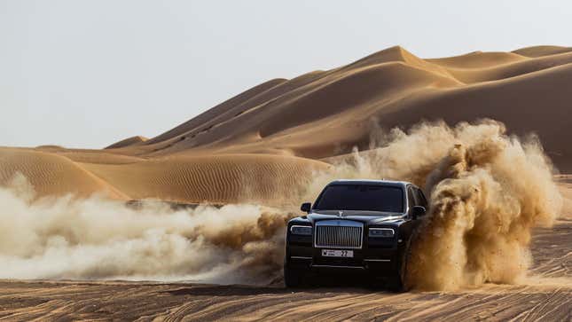 A photo of a black Rolls Royce Cullinan SUV. 