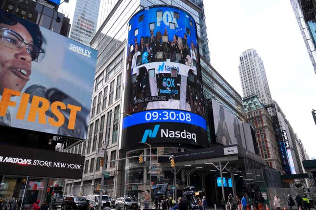 FILE - Pedestrians walk past the Nasdaq building Tuesday, March 26, 2024, in New York. Last year, a handful of Big Tech stocks were behind much of corporate America’s profit growth. Now, as the heart of earnings reporting season arrives on Wall Street, the hope is that profit growth will broaden out to a wider range of companies. (AP Photo/Frank Franklin II, File)