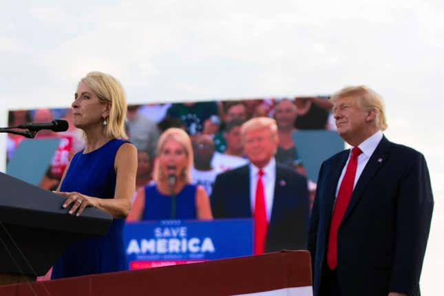 U.S. Rep. Mary Miller, of Illinois, speaks as former President Donald Trump stands behind her on stage at a rally at the Adams County Fairgrounds in Mendon, Ill.