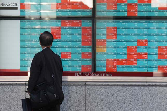 FILE - A person looks at an electronic stock board showing Japan&#39;s Nikkei 225 index at a securities firm Friday, Jan. 26, 2024, in Tokyo. Asian shares were mixed on Thursday after Wall Street fell to its worst loss since September as the Federal Reserve indicated cuts to interest rates are not imminent. (AP Photo/Eugene Hoshiko, File)