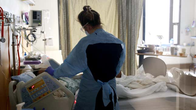 Nurse Elisa Gilbert checks on a patient in the acute care covid-19 unit at the Harborview Medical Center on January 21, 2022 in Seattle, Washington. 