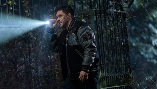 Eddie Brock (Tom Hardy) holds a flashlight in a dark scene from Venom 2: Let There Be Carnage