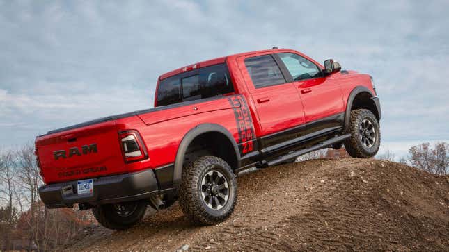 An orange Ram 2500 Power Wagon on a mound of dirt.