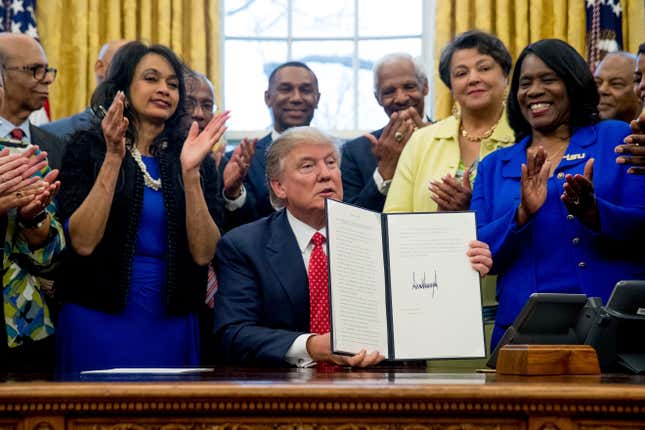 President Donald Trump holds up the Historically Black Colleges and Universities HBCU Executive Order after signing it, on Feb. 28, 2017, in the Oval Office.
