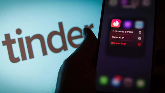 A phone screen displays the Tinder app.