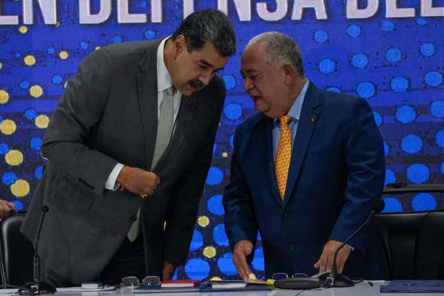 Venezuela&#39;s President Nicolas Maduro, left, speaks with National Electoral Council President Elvis Hidrobo Amoroso during the notification ceremony for the referendum about the future of a disputed territory with Guyana, in Caracas, Venezuela, Monday, Dec. 4, 2023. (AP Photo/Ariana Cubillos)