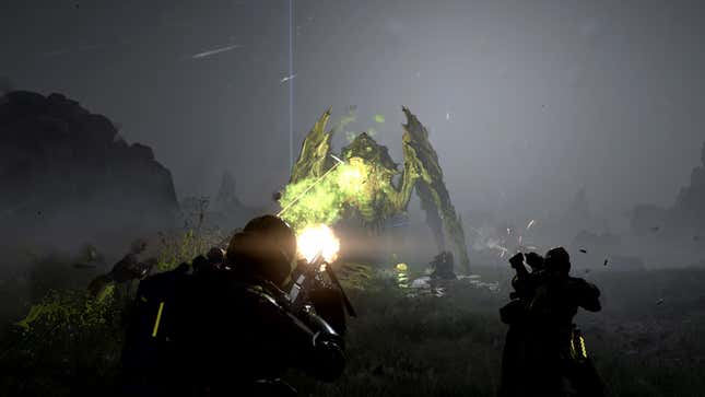 A big alien bug spews green slime at a duo of Helldivers.