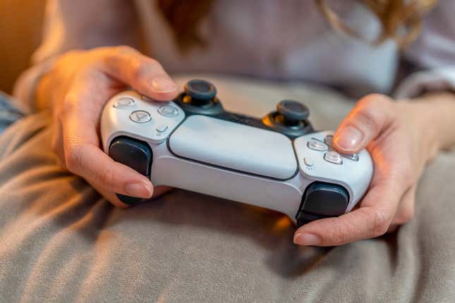 close up of hands holding a gaming controller