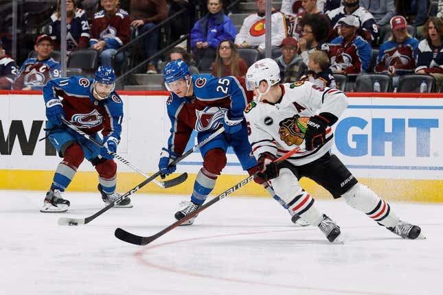 Oct 19, 2023; Denver, Colorado, USA; Colorado Avalanche right wing Logan O&#39;Connor (25) controls the puck ahead of center Andrew Cogliano (11) as Chicago Blackhawks defenseman Connor Murphy (5) defends in the second period at Ball Arena.