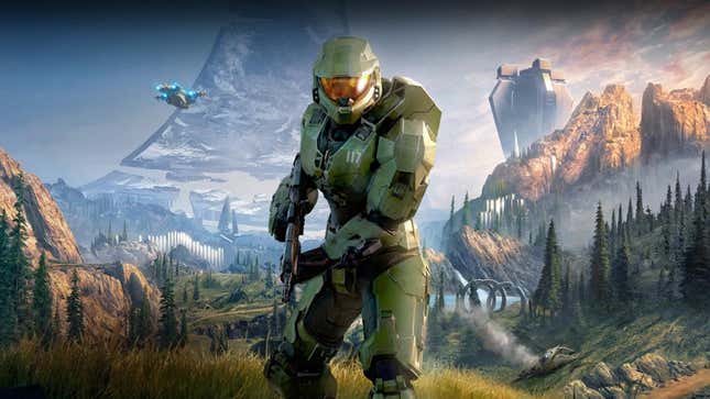 Master Chief holds a gun with a landscape behind him.