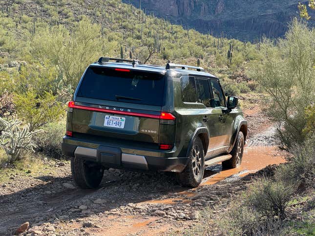 Rear 3/4 view of a green 2024 Lexus GX 550 Overtrail off-roading