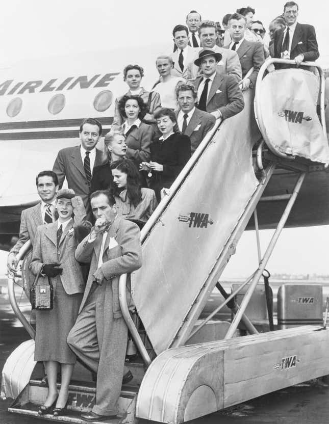 The actors on their return trip to Hollywood. They are (left to right, front row), Richard Conte, Lauren Bacall, and Humphrey Bogart; (second row), Paul Henreid, June Havoc, and Geraldine Brooks; (third row), Marsha Hunt and Evelyn Keyes; (fourth row), Jane Wyatt and Danny Kaye; (fifth row), Mrs. Stirling Hayden and Gene Kelly. Stirling Hayden is directly back of Kelly. October 29, 1947.