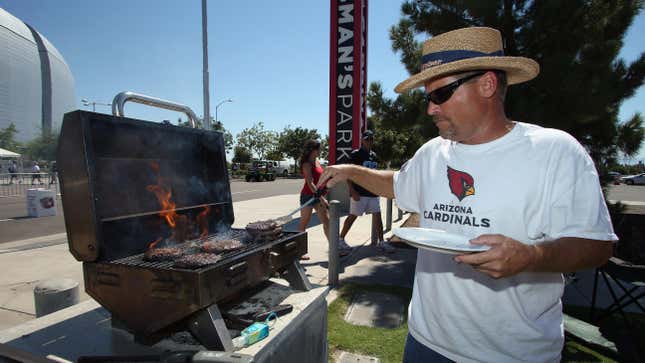 An Arizona Cardinals fan grills hamburgers prior to the start of the game against the Detroit Lions at University of Phoenix Stadium on September 15, 2013 in Glendale, Arizona.