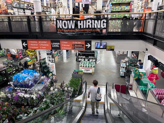 Now Hiring banner inside a Home Depot store in New York City.