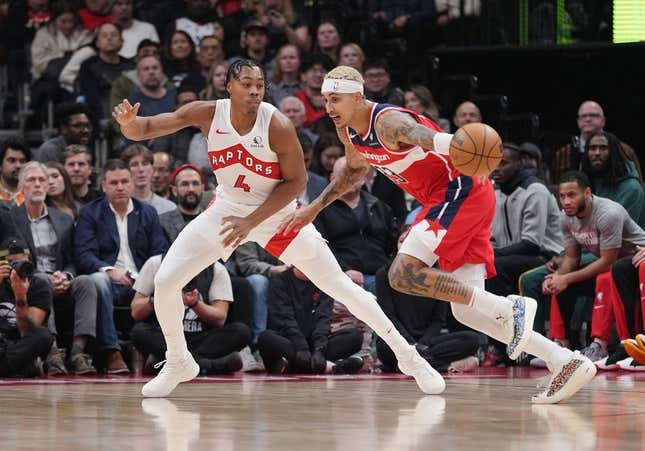 Nov 13, 2023; Toronto, Ontario, CAN; Washington Wizards forward Kyle Kuzma (33) controls the ball as Toronto Raptors forward Scottie Barnes (4) defends during the first quarter at Scotiabank Arena.