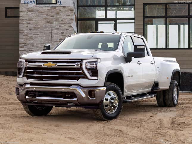 A front 3/4 shot of a white Silverado HD with its mirrors looking like the pipes under your sink