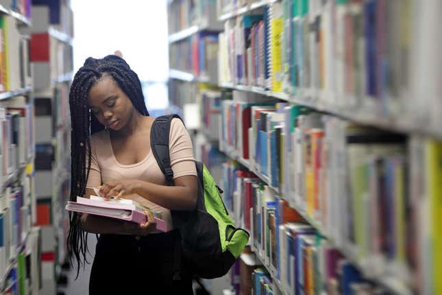 Black girl reading in a library